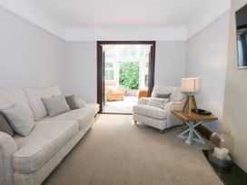 A living room with a sofa and armchair at Fairfield in Llanbedrog