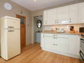 A kitchen with a fridge and countertop at Fairfield in Llanbedrog