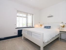 A bedroom with a bed and nightstands at Fairfield in Llanbedrog