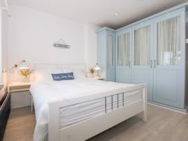 A bedroom with a bed and wardrobe at Fairfield in Llanbedrog