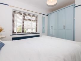 A bedroom with a bed and wardrobe at Fairfield in Llanbedrog