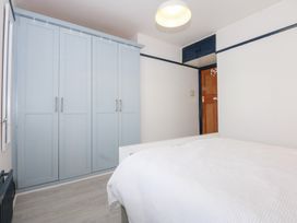 A bedroom with a wardrobe and bed at Fairfield in Llanbedrog