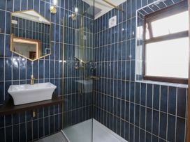 A bathroom with a sink and shower at Fairfield in Llanbedrog