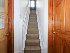 A staircase in a hallway at Fairfield in Llanbedrog