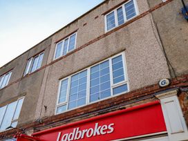 The exterior of a building with multiple windows above a Ladbrokes store sign in Filey