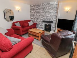 A living room with sofas and a television at Bluebell Cottage in Flamborough