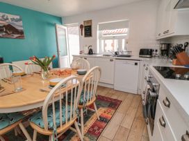 A kitchen with a dining table and chairs at Bluebell Cottage in Flamborough
