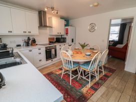 A kitchen with a dining table and chairs at Bluebell Cottage in Flamborough