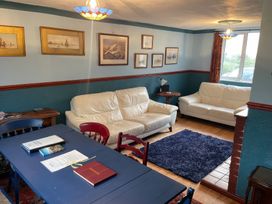 A living room with sofas and a table at 11 Penygroes in Llanddeusant