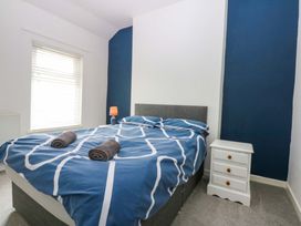 A bedroom with a bed and bedside table at Y Berth in Caernarfon