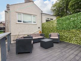 An outdoor seating area with furniture and a fence at Y Berth in Caernarfon