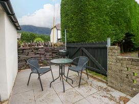 A patio with a table and chairs at Y Berth in Caernarfon