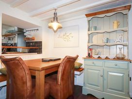 A dining area with chairs and a table at Woodview in Looe