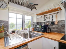 A kitchen with a sink and coffee maker at Woodview in Looe