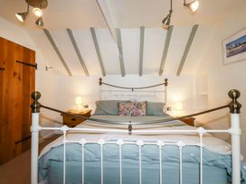 A bedroom with a bed and bedside table at Woodview in Looe