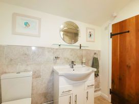 A bathroom with a sink and toilet at Woodview in Looe