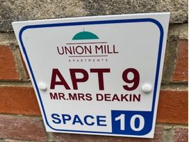 A sign for apartment 9 and space 10 at Union Mill Apartments in Whitby