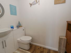 A bathroom with a sink and toilet at Swallows Retreat in Tenby