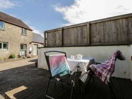 An outdoor seating area with table and chairs at Swallows Retreat in Tenby