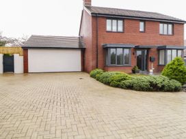 A brick semi detached house with a double garage and paved driveway at 2 White Rock Court in Paignton