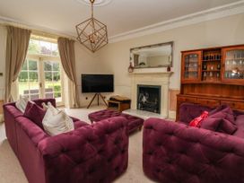 A living room with a television and a fireplace at Kexby House 