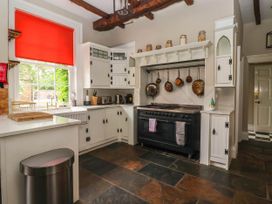 A kitchen with cabinets and a stove at Kexby House