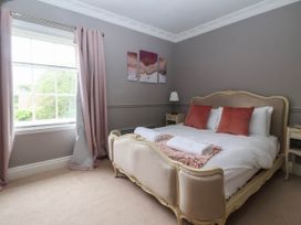 A bedroom with a bed and window at Kexby House