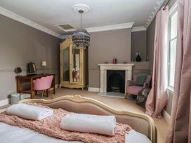 A bedroom with a bed and fireplace at Kexby House