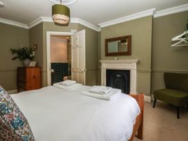 A bedroom with a bed and towels at Kexby House