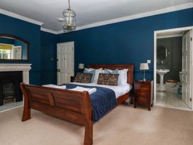 A bedroom with a bed and ensuite bathroom at Kexby House