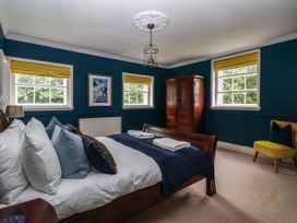 A bedroom with a bed and wardrobe at Kexby House