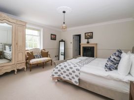 A bedroom with a bed and an armoire at Kexby House