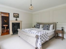A bedroom with a bed and bedside tables at Kexby House
