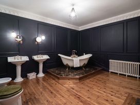 A bathroom with a bathtub and sinks at Kexby House