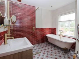 A bathroom with a shower, bathtub, and sink at Kexby House