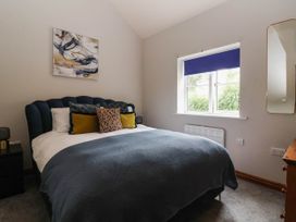 A bedroom with a bed and painting at Kexby House 