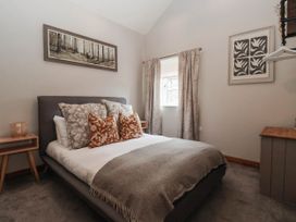 A bedroom with a bed and window at Kexby House