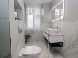 A bathroom with a toilet and sink at Beckmead in Windermere