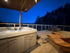 An outdoor area with a hot tub and seating at Bryn Hafod in Llandrindod Wells