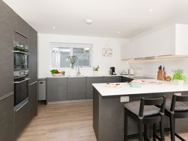 A kitchen with a sink and oven at Sandy Cove in Praa Sands