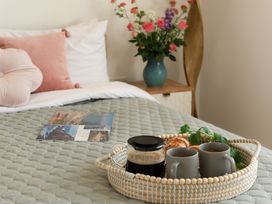 A bedroom with a bed and a tray of coffee at Sandy Cove in Praa Sands