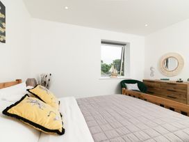 A bedroom with a bed and window at Sandy Cove, Praa Sands
