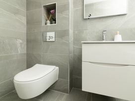 A bathroom with a toilet and sink at Sandy Cove in Praa Sands