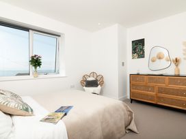 A bedroom with a bed and window at Sandy Cove in Praa Sands