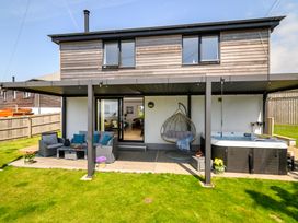 An outdoor area with seating and a whirlpool spa at Sandy Cove in Praa Sands