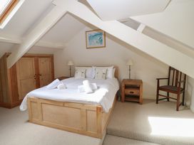 A bedroom with a bed and a nightstand at Kipper Lodge in Dartmouth