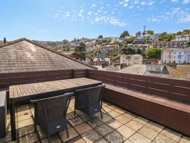 An outdoor area with a table and chairs at Kipper Lodge in Dartmouth