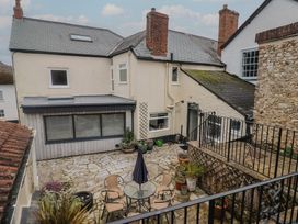 An outdoor patio with a table, chairs, and plants at The Fernery in Colyton
