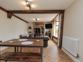 A living room with a table and sofa at Betsy's Burrow