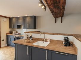 A kitchen with cabinets, sink, and appliances at Betsy's Burrow